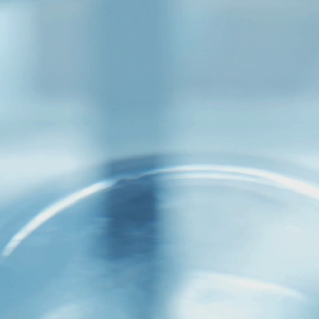 A droplet of water falling into pool of water.