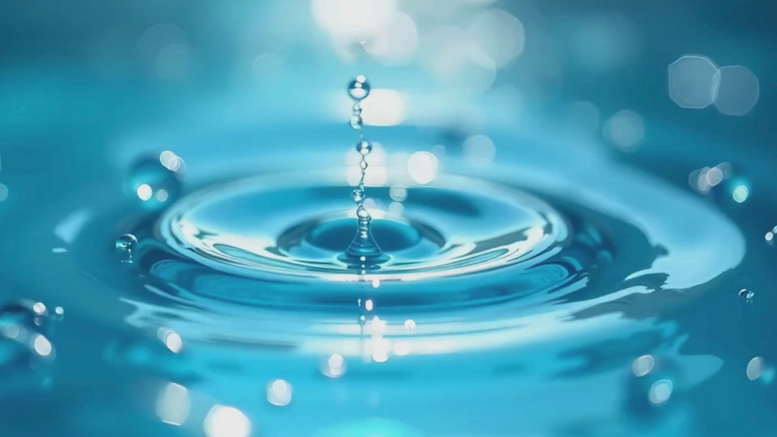 Cool blue water dripping into a puddle of water
